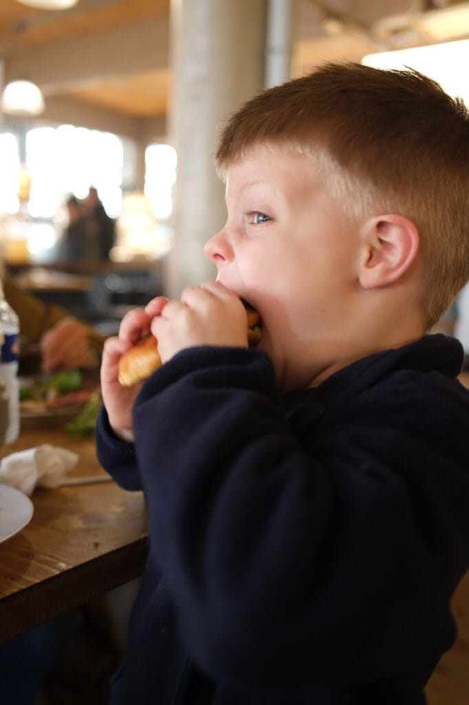 One of the Sommer children eating a snack while traveling.