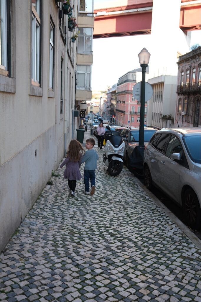 The Sommer children walking down a narrow cobblestone street in Europe.