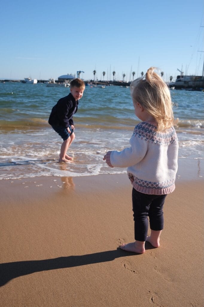 Two of the Sommer children playing at the shoreline.